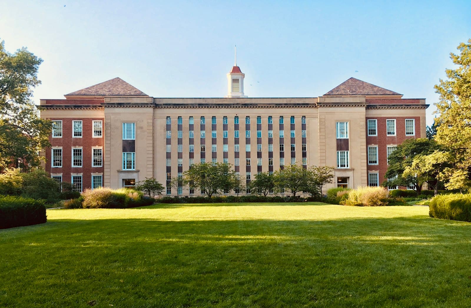 Quiet university courtyard with empty walkways and brick halls